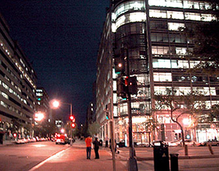 Office buildings and street at night.