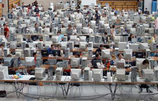A photograph of a venue where multiple computers have been set up and networked.