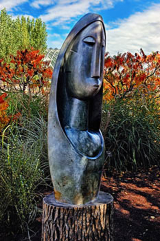 Sculpture of a woman titled 'Woman of Wisdom' by Nicholas Mukomberanwa.