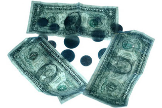 Photograph of US dollars and coins on a light table.