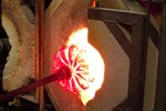 Photograph of a piece being blown to the right size.
