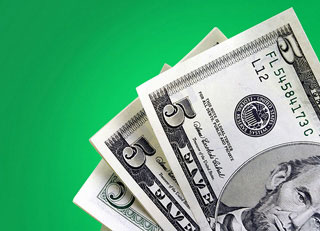 Three five-dollar bills on a green background.