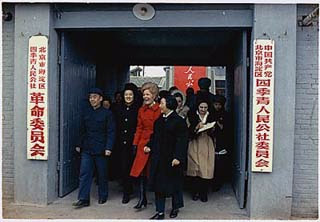 A photo of Mrs. Nixon walking through a large doorway with a crowd of people. A photo of Mrs. Nixon walking through a large doorway with a crowd of people.