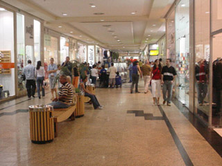 A photo of a crowded shopping mall hallway. A photo of a crowded shopping mall hallway.