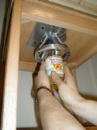 Easy Jar Opener: Attaches below upper kitchen cabinets, grip jar with two hands and twist cap off easily.