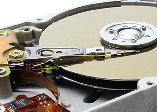 Photo of the inside of a hard drive. Photo of the inside of a hard drive.