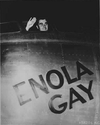 Col. Paul W. Tibbets, Jr. waves from the cockpit of the Enola Gay.