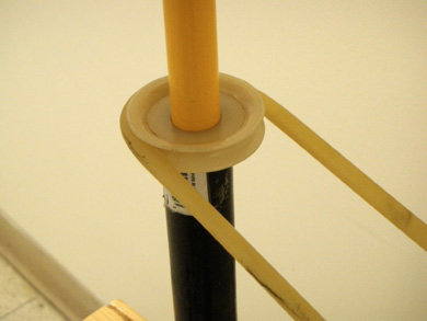 Photo of rubber tubing around a pulley wheel.