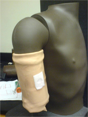 Two photos of a dummy torso with mockup bandage one static, one showing injecting nitrite solution to stimulate the color change reaction.