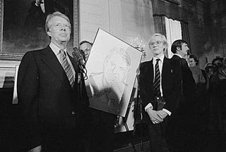 A black and white photo of President Carter and Andy Warhol.