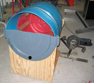 A large plastic drum connected to a bicycle pedal assembly.